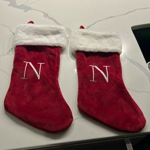 Two red Christmas stockings both letter N used once